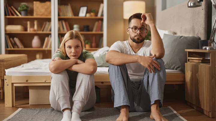 strange behaviors that perplex women most about men man with strange behavior sitting next to woman on floor