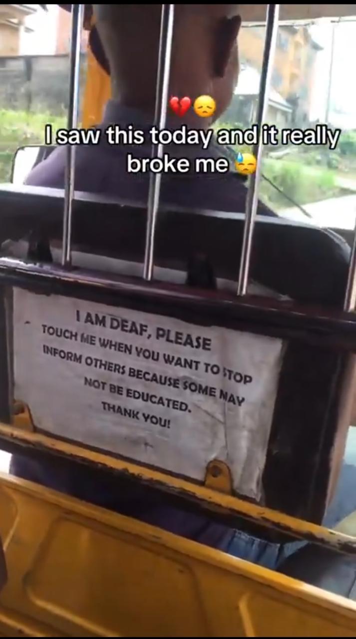I am deaf, please tap me when you want to stop  passenger shares touching notice a Keke driver placed in his tricycle